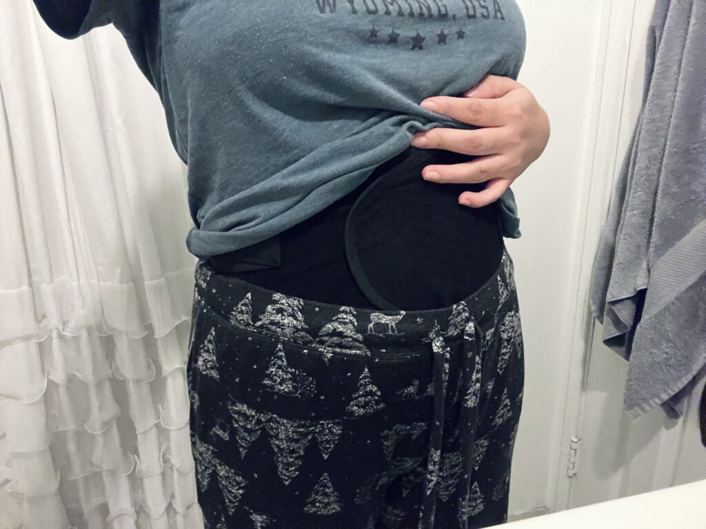 A woman wearing a postpartum belly wrap after giving birth.